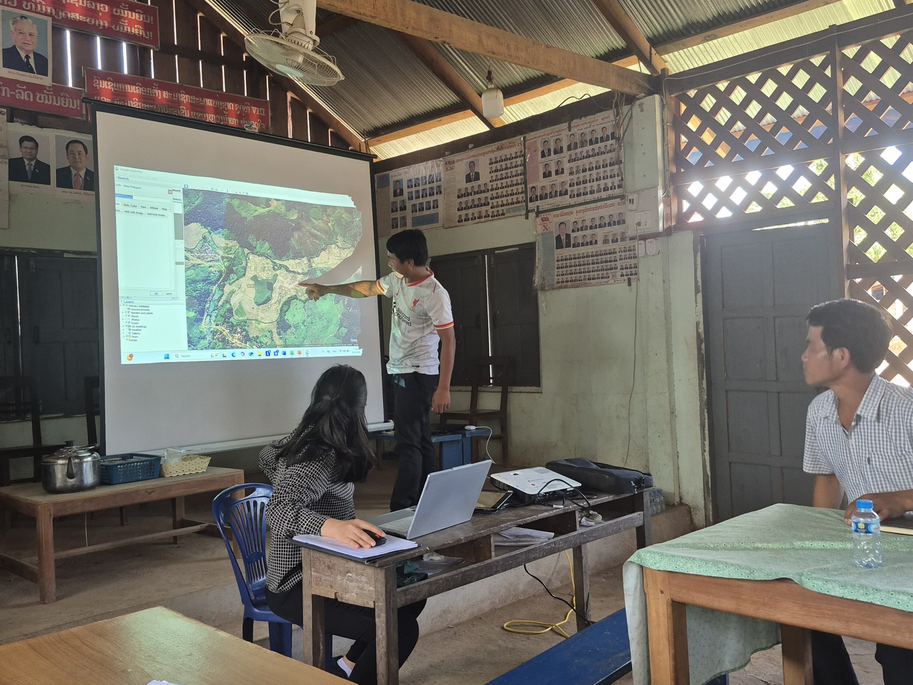one of the village representatives showing on the map where climate risks are happening.jpg